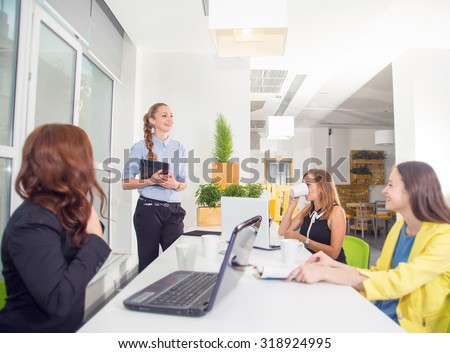 Group of women listen to the presentation. To participate in the training sessions. Team members listening attentively to a cheerful business woman holding a presentation. Make a report on the results