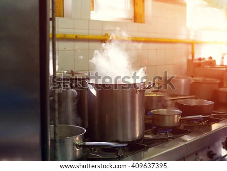 Prepare a lot of food. In a saucepan, boil the water. Cook. Restaurant kitchen. The restaurant\'s cuisine. Hot time. Industrial kitchen. Cooking food - process.