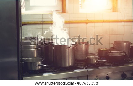 Prepare a lot of food. In a saucepan, boil the water. Cook. Restaurant kitchen. The restaurant's cuisine. Hot time. Industrial kitchen. Cooking food - process.