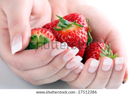 Fresh strawberries in hands against white background