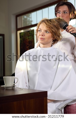 Beautiful young woman gets a hairdo in the beauty-shop
