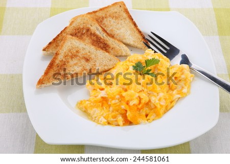 breakfast with scrambled eggs, toasts