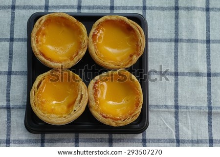 Egg Tart in plastic tray on cloth background