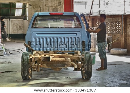 NONG KHAI, THAILAND - October 30, 2015: Worker repair pickup car in the garage in Nong Khai, Thailand