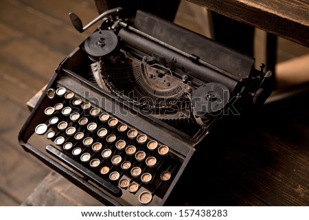 old typewriter with Russian letters on a wooden background