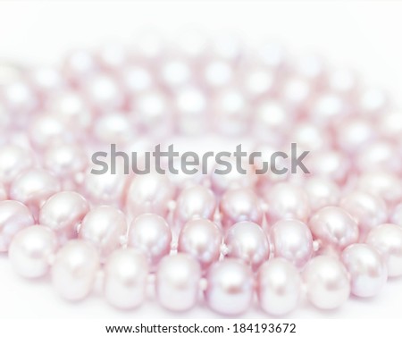 string of pearls delicate pink color, in soft focus, with highlights