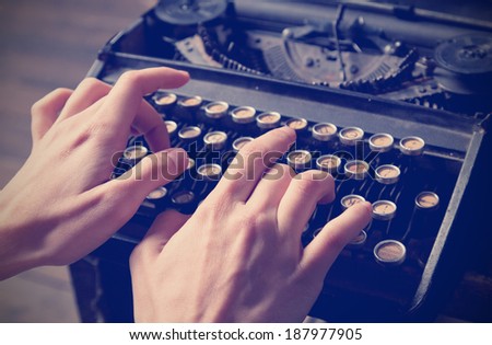 Human hand prints on retro typewriter. Close up. Instagram effect