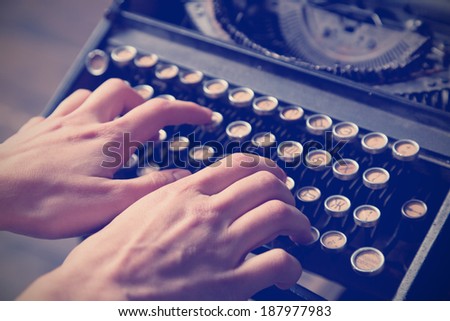Human hand prints on retro typewriter. Close up. Instagram effect