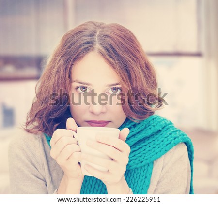 young woman in blue scarf with white mug, indoor,  image with instagram effect