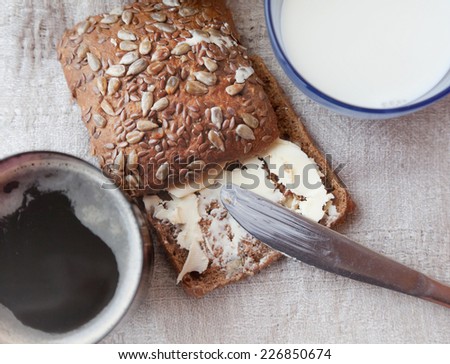 grain rye bread and butter, coffee and cup of milk, with selective soft focus
