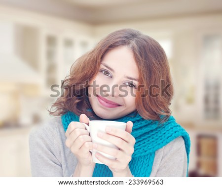 beautiful young woman with white mug in hand, smiling