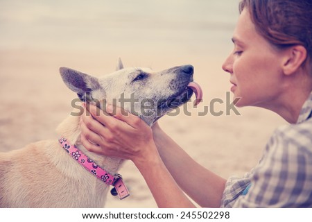 The owner with her dog on the beach. Best friends,