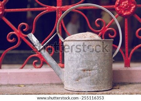old iron watering can
