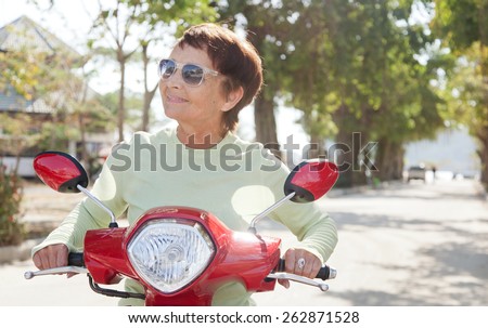 beautiful elderly woman on motorbike