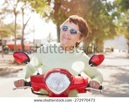 beautiful elderly woman 50 years old on motorbike
