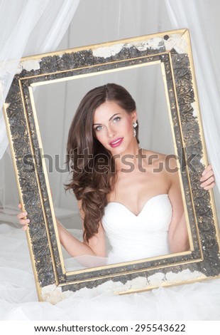 beautiful woman in a wedding dress on the bed, posing in the frame
