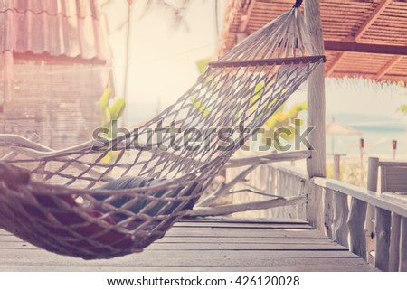 Hammock in the cafe on the shore of tropical sea