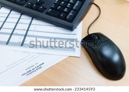 computer mouse on desk and sheet