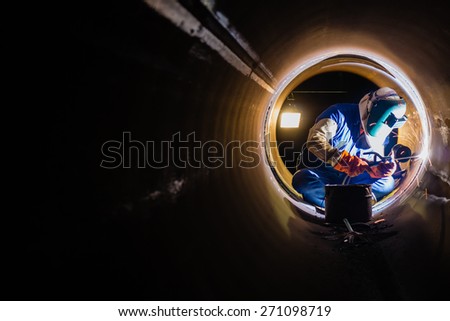 Workers welding work at night in the pipeline.