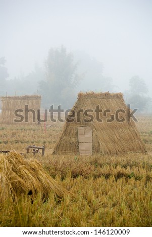 Straw and rice straw huts in fog