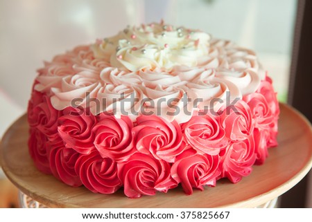 Pink  wedding cake decorated with cream roses close up