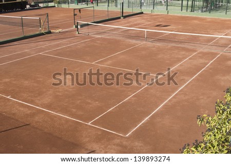 Clay surface tennis court. Dirt surface tennis court