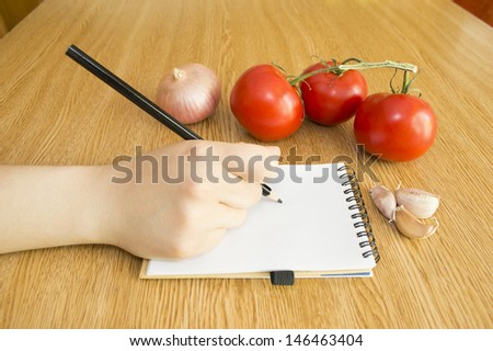 write in Notebook and Fresh Vegetables Background Diet in table