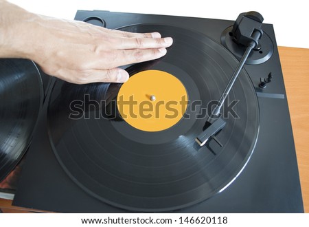 DJ mixing vinyl record on a  turntable with hand