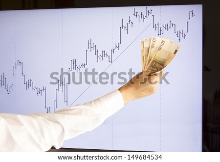 stockbroker giving approval  with a euros in hand (fictitious market data)