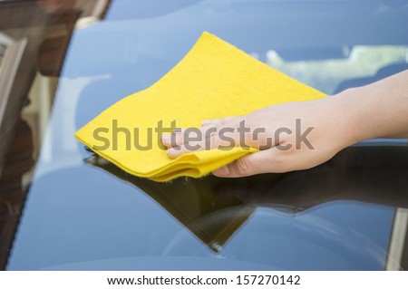 Man cleaning car glass front