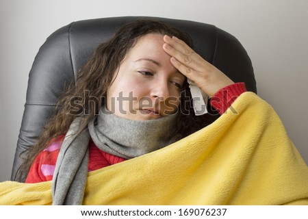 very sick woman with scarf and high fever