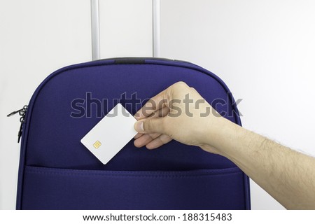 close up of a suitcase and a man keeping the credit card to go to sea on vacation