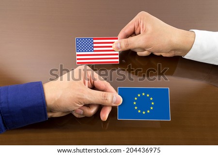 business executive exchanging business card with europe and usa Flag