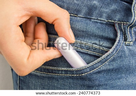 cropped  shot of a woman s pocket taking tampon