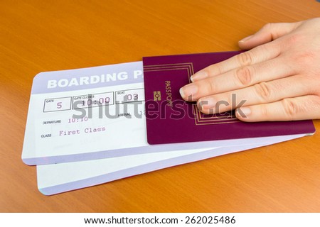 hand delivering passport and boarding pass