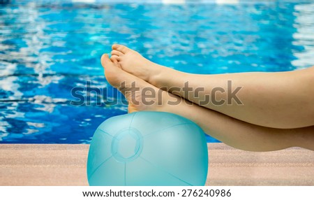 relaxed person with feet above the ball on the pool