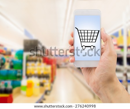 Closeup of hands using smartphone in supermarket .screen content is designed by us and not copyrighted by others and created with wacom tablet and ps