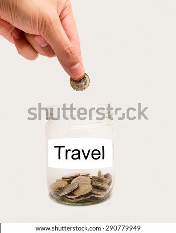 copper coins in an open glass jar in concept for savings and home finances and Label with the word travel