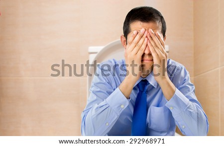businessman in the toilet with problems of constipation