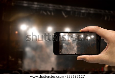 man filming a concert with your mobile phone No person
