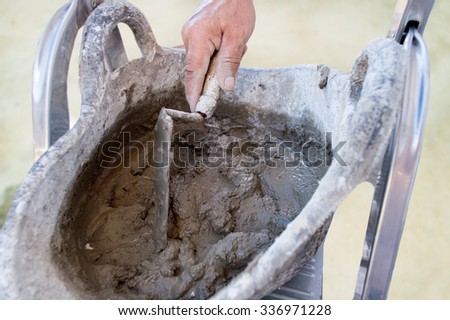 detail of construction worker is making wet cement