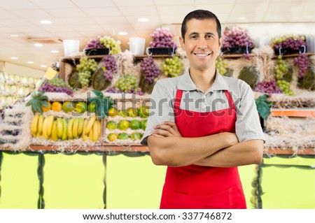 portrait of shopman at the fruits store with crossing arms