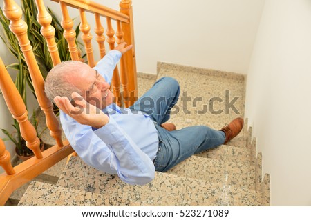 senior man falling down on stairs with hands up to try to catching the railing