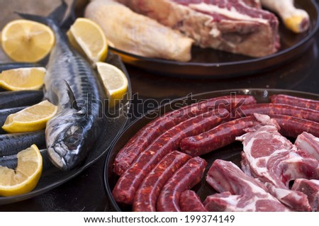 Raw meat and fish ready to grill