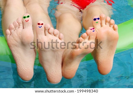 Feet fun faces in a swimming pool
