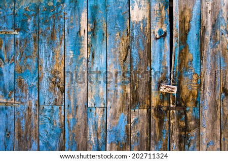 Close up of an antique wooden door painted in blue