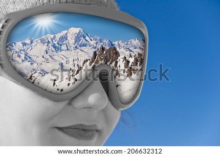 Close up of a girl with a ski mask and reflection of the Mont Blanc
