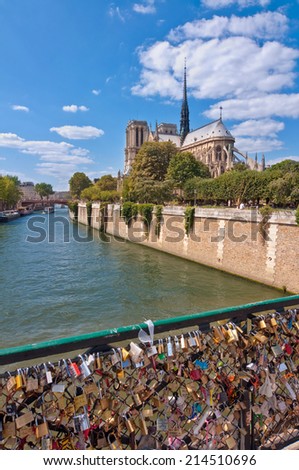 PARIS, FRANCE - JULY 7: Notre Dame de Paris and the river Seine with love locks placed by tourists in the foreground, on July 7, 2011 in Paris, France.