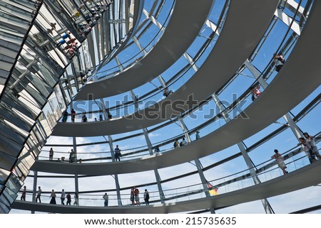 BERLIN, GERMANY - AUGUST 9: Tourists visiting the Reichstag dome, a modern glass dome constructed on top of the rebuilt Reichstag building, on August 9, 2014 in Berlin, Germany.