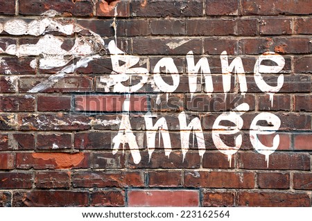 Bonne annee, meaning Happy new Year in French, on a brick wall, street-art style